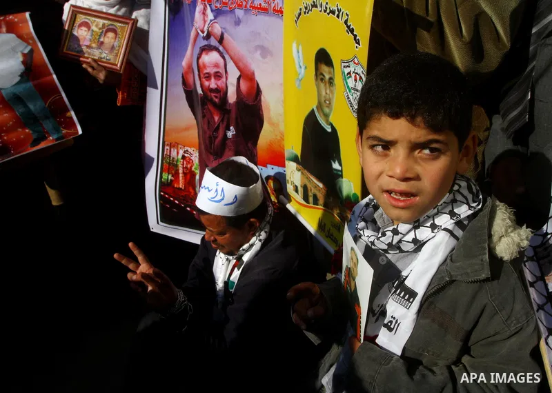 Families of Palestinian prisoners held in Israeli jails take part in a demonstration demanding their release, outside the Red Cross office in Gaza City, Jan. 21, 2012. Photo by Ashraf Amra