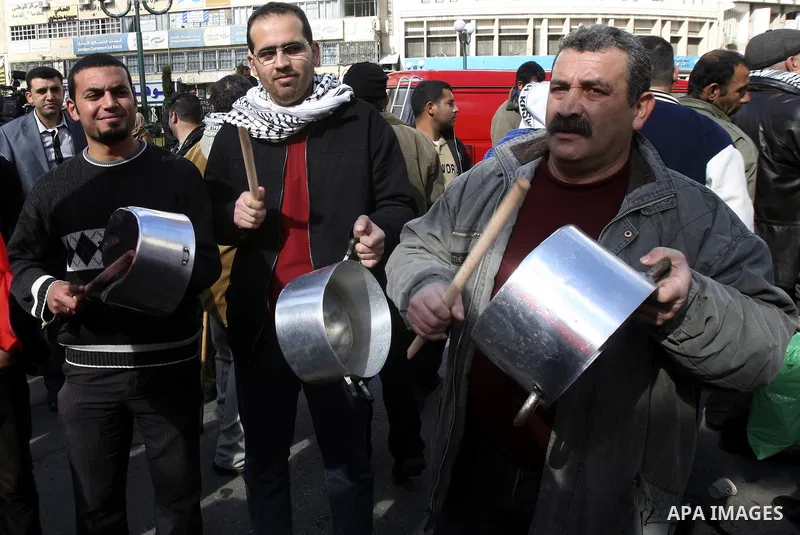 Palestinian demonstrators bang on pots as they march in the West Bank city of Nablus to protest against the government's recently announced economic austerity measures on January 21, 2012. Photo by Wagdi Eshtayah