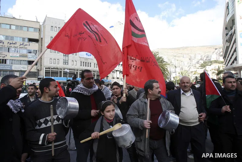Palestinian demonstrators bang on pots as they march in the West Bank city of Nablus to protest against the government's recently announced economic austerity measures on January 21, 2012. Photo by Wagdi Eshtayah