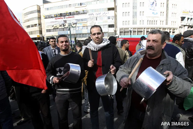 Palestinian demonstrators bang on pots as they march in the West Bank city of Nablus to protest against the government's recently announced economic austerity measures on January 21, 2012. Photo by Wagdi Eshtayah