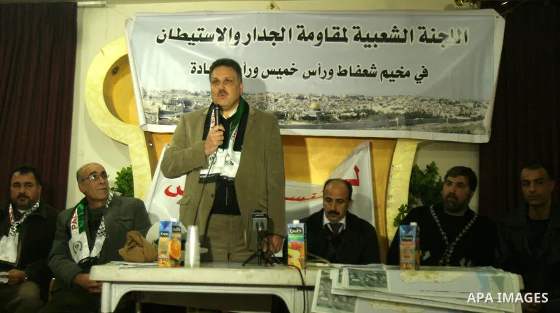Palestinians attend a press conference organized by the Popular Committee against the Israeli seperation barrier and settlement in Jerusalem's neighbourhood of Shuafat on Jan. 21,2012. Photo by Mahfouz Abu Turk