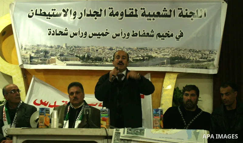 Palestinians attend a press conference organized by the Popular Committee against the Israeli seperation barrier and settlement in Jerusalem's neighbourhood of Shuafat on Jan. 21,2012. Photo by Mahfouz Abu Turk