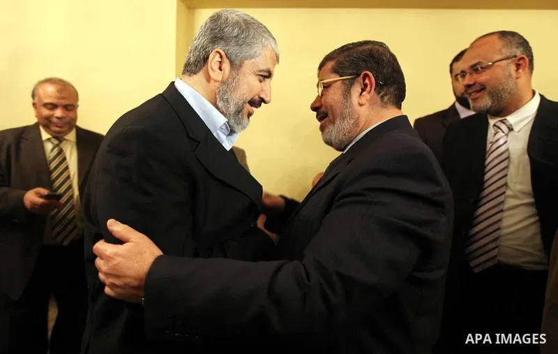 A handout photograph released by the Hamas Press Office shows Leaders of the newly formed Freedom and Justice Party, President Mohammed Morsy, meets with Palestinian Hamas leader Khaled Meshaal (R) in Cairo, Egypt, 21 Ja...