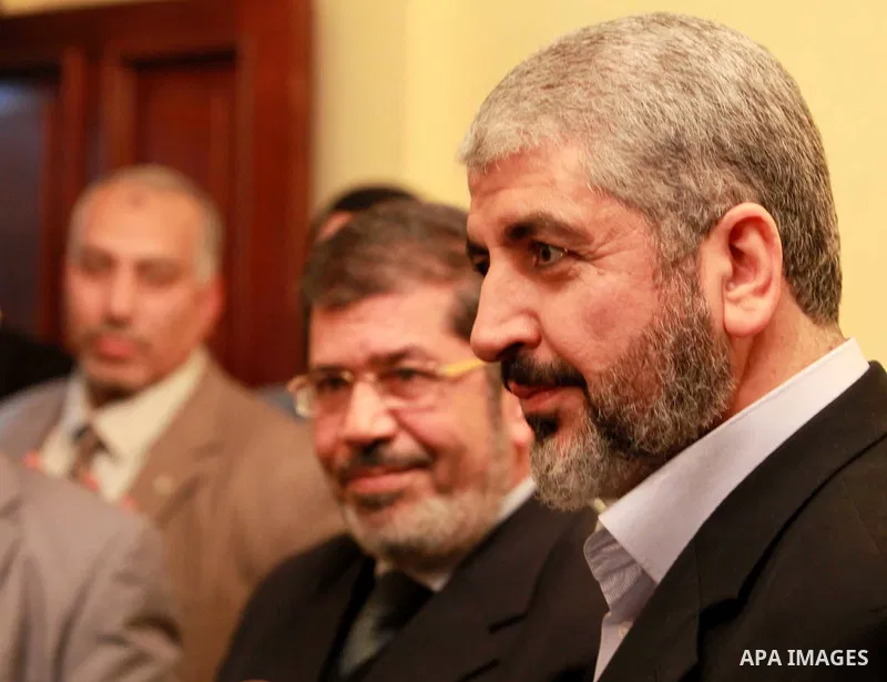 A handout photograph released by the Hamas Press Office shows Leaders of the newly formed Freedom and Justice Party, President Mohammed Morsy, meets with Palestinian Hamas leader Khaled Meshaal (R) in Cairo, Egypt, 21 Ja...