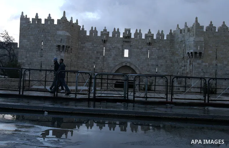 Palestinians walk during heavy rains outside Damascus Gate leading into the Al-Aqsa Mosque compound, Islam's third holiest site in the old city of Jerusalem, on Jan. 22, 2012. Photo by Mahfouz Abu Turk