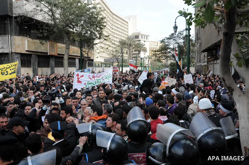 Egyptians gather outside the parliament during the first parliament session after the revolution that ousted former President Hosni Mubarak, in Cairo January 23, 2012. Egypt's parliament began its first session on Monday...
