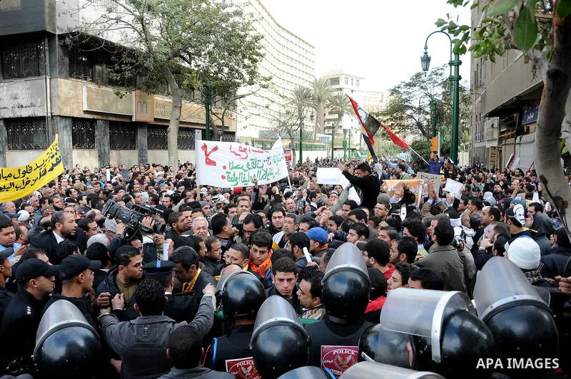 Egyptians gather outside the parliament during the first parliament session after the revolution that ousted former President Hosni Mubarak, in Cairo January 23, 2012. Egypt's parliament began its first session on Monday...