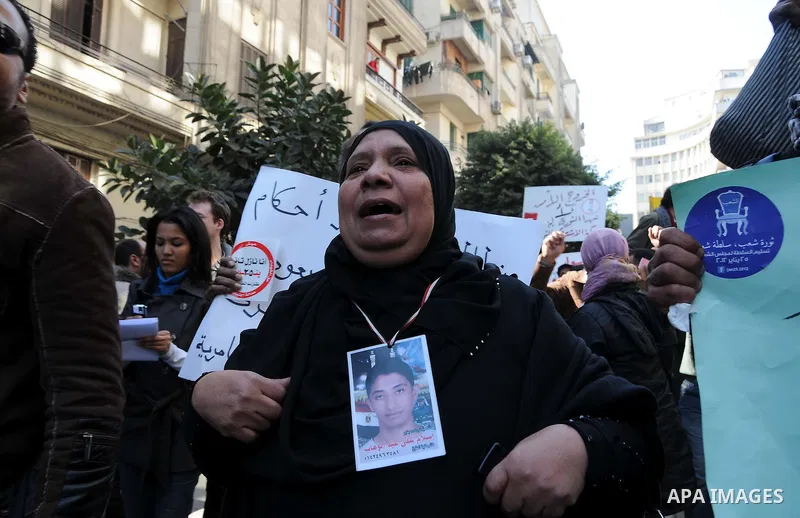 Egyptians gather outside the parliament during the first parliament session after the revolution that ousted former President Hosni Mubarak, in Cairo January 23, 2012. Egypt's parliament began its first session on Monday...