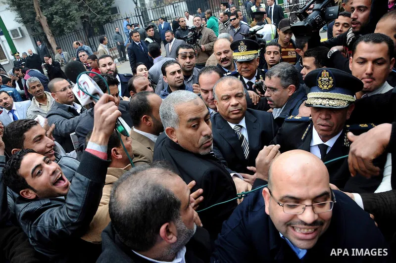 Egyptians gather outside the parliament during the first parliament session after the revolution that ousted former President Hosni Mubarak, in Cairo January 23, 2012. Egypt's parliament began its first session on Monday...