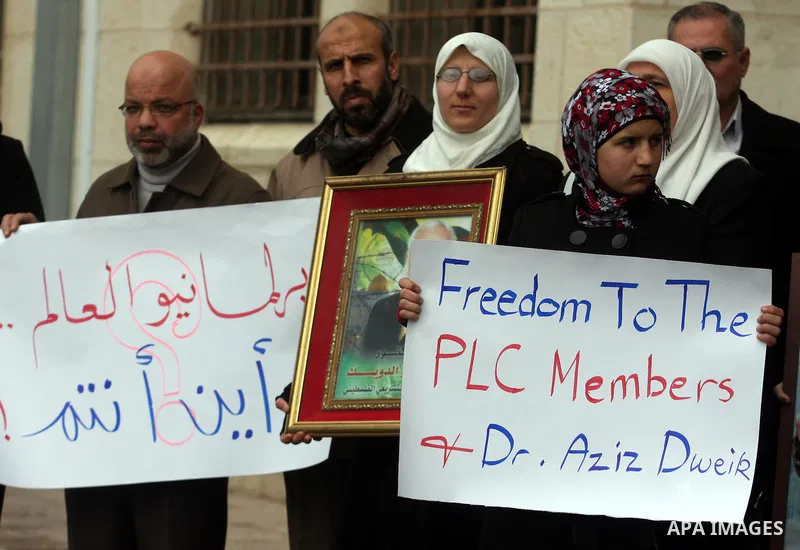 Palestinian women and a Legislative Council members participate in a protest in solidarity with Palestinian parliamentary speaker and Hamas member Abdel Aziz Duaik, in the West Bank city of Ramallah Monday, Jan. 23, 2012...