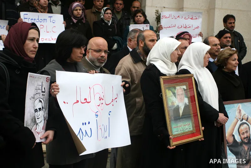 Palestinian women and a Legislative Council members participate in a protest in solidarity with Palestinian parliamentary speaker and Hamas member Abdel Aziz Duaik, in the West Bank city of Ramallah Monday, Jan. 23, 2012...