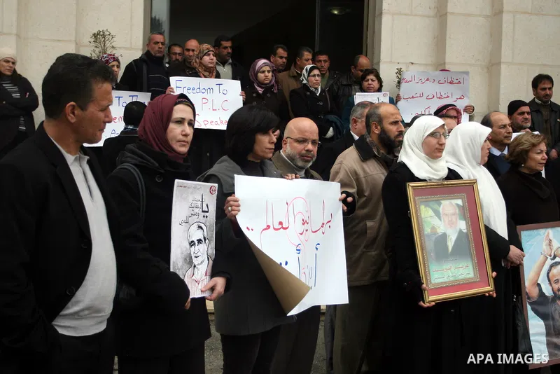 Palestinian women and a Legislative Council members participate in a protest in solidarity with Palestinian parliamentary speaker and Hamas member Abdel Aziz Duaik, in the West Bank city of Ramallah Monday, Jan. 23, 2012...