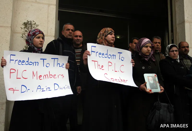 Palestinian women and a Legislative Council members participate in a protest in solidarity with Palestinian parliamentary speaker and Hamas member Abdel Aziz Duaik, in the West Bank city of Ramallah Monday, Jan. 23, 2012...