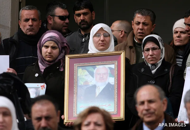 Palestinian women and a Legislative Council members participate in a protest in solidarity with Palestinian parliamentary speaker and Hamas member Abdel Aziz Duaik, in the West Bank city of Ramallah Monday, Jan. 23, 2012...