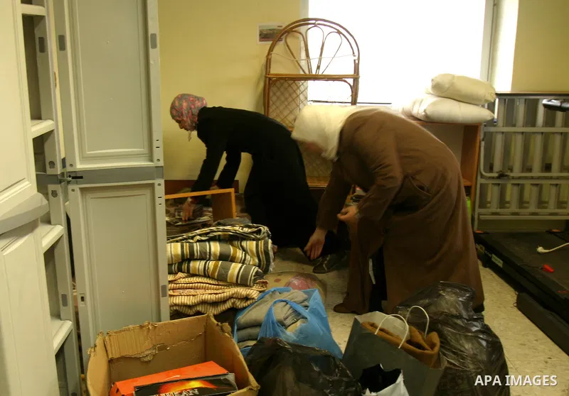 Relatives of Palestinian Khaled abu Arafeh and Mohammed Totah collect their belongings at the international Red Cross offices in east Jerusalem after Israeli police arrested on January 23, 2012 two senior Hamas officials...