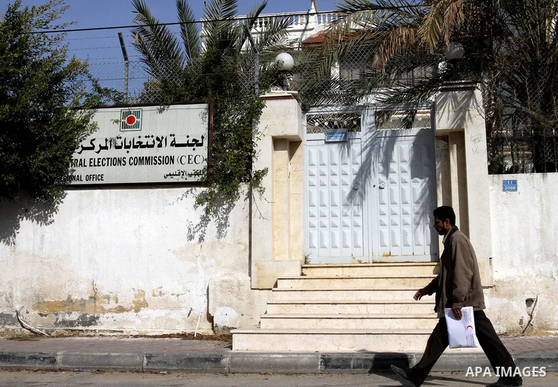 A Palestinian man walks past the Central Elections Commission (CEC) headquarters in Gaza city on Jan. 24,2012. The head of the regional office of the central elections commission in Gaza Strip, Jameel al-Khaldi said that...