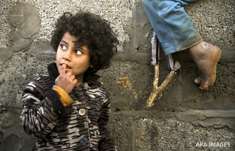 Palestinian children play between makeshift tents in one of the poorest regions in the Al-Zaiton neighbourhood, in the Gaza strip, on 24 January 2012. With high rates of unemployment and lack of work opportunities in Gaz...