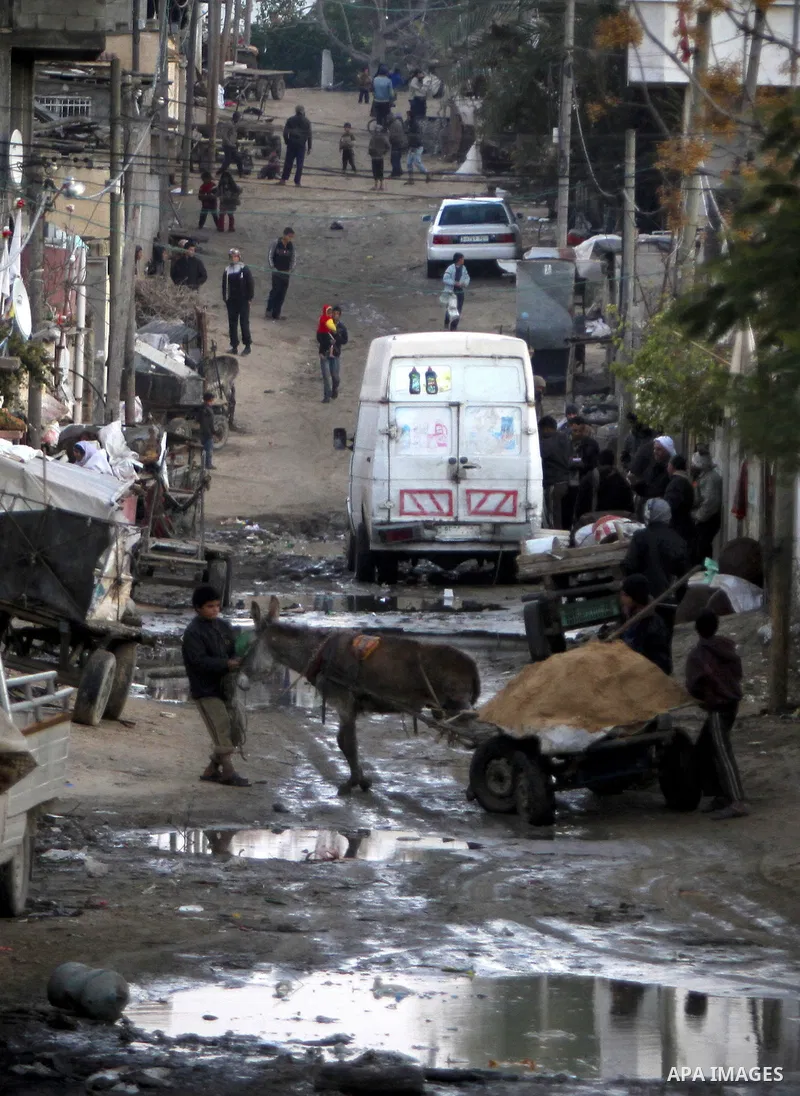 Palestinians gather in a road in one of the poorest regions in the Al-Zaiton neighbourhood, in the Gaza strip, on 24 January 2012. With high rates of unemployment and lack of work opportunities in Gaza, an increasing num...