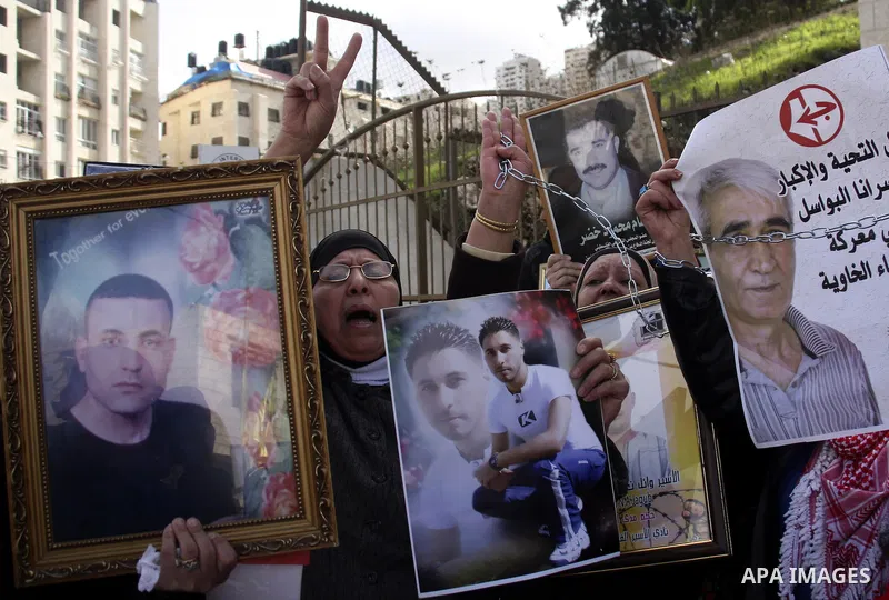 Palestinians participate in a demonstration calling for release of Palestinian prisoners held in the Israeli jails . in the West Bank city of Nablus, Jan. 25, 2012. Israel is currently holding thousands of Palestinians i...