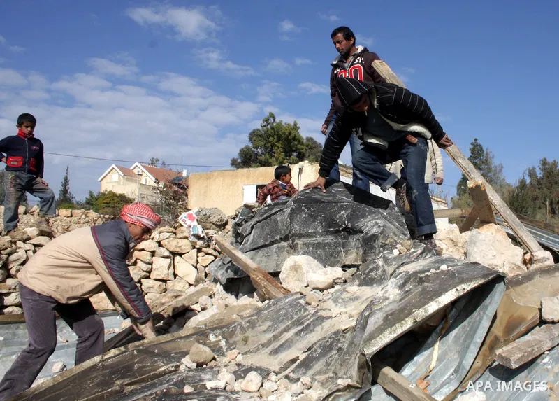 Palestinian bedouin inspect their destroyed house in Oum al-Khair village southern West Bank city of Hebron after the house was destroyed by the Israeli army on January 25, 2012. Photo by Mamoun Wazwaz