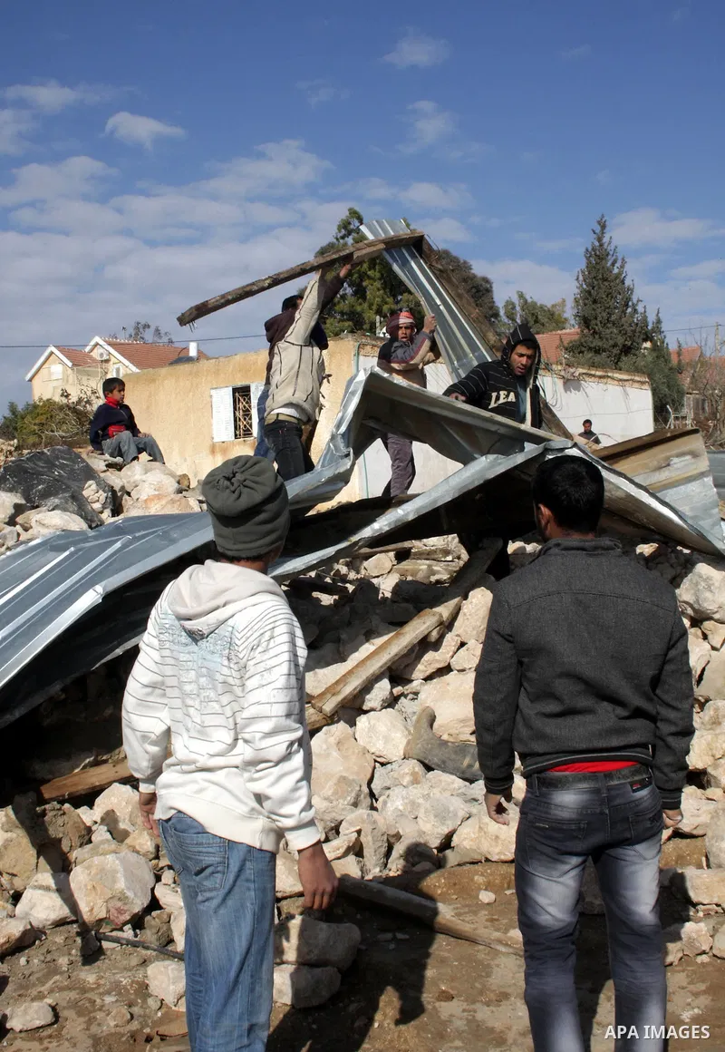 Palestinian bedouin inspect their destroyed house in Oum al-Khair village southern West Bank city of Hebron after the house was destroyed by the Israeli army on January 25, 2012. Photo by Mamoun Wazwaz