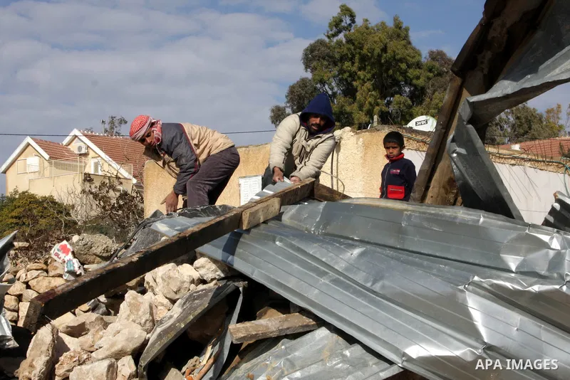 Palestinian bedouin inspect their destroyed house in Oum al-Khair village southern West Bank city of Hebron after the house was destroyed by the Israeli army on January 25, 2012. Photo by Mamoun Wazwaz