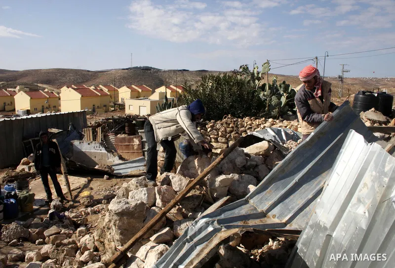 Palestinian bedouin inspect their destroyed house in Oum al-Khair village southern West Bank city of Hebron after the house was destroyed by the Israeli army on January 25, 2012. Photo by Mamoun Wazwaz