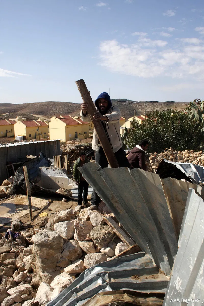 Palestinian bedouin inspect their destroyed house in Oum al-Khair village southern West Bank city of Hebron after the house was destroyed by the Israeli army on January 25, 2012. Photo by Mamoun Wazwaz
