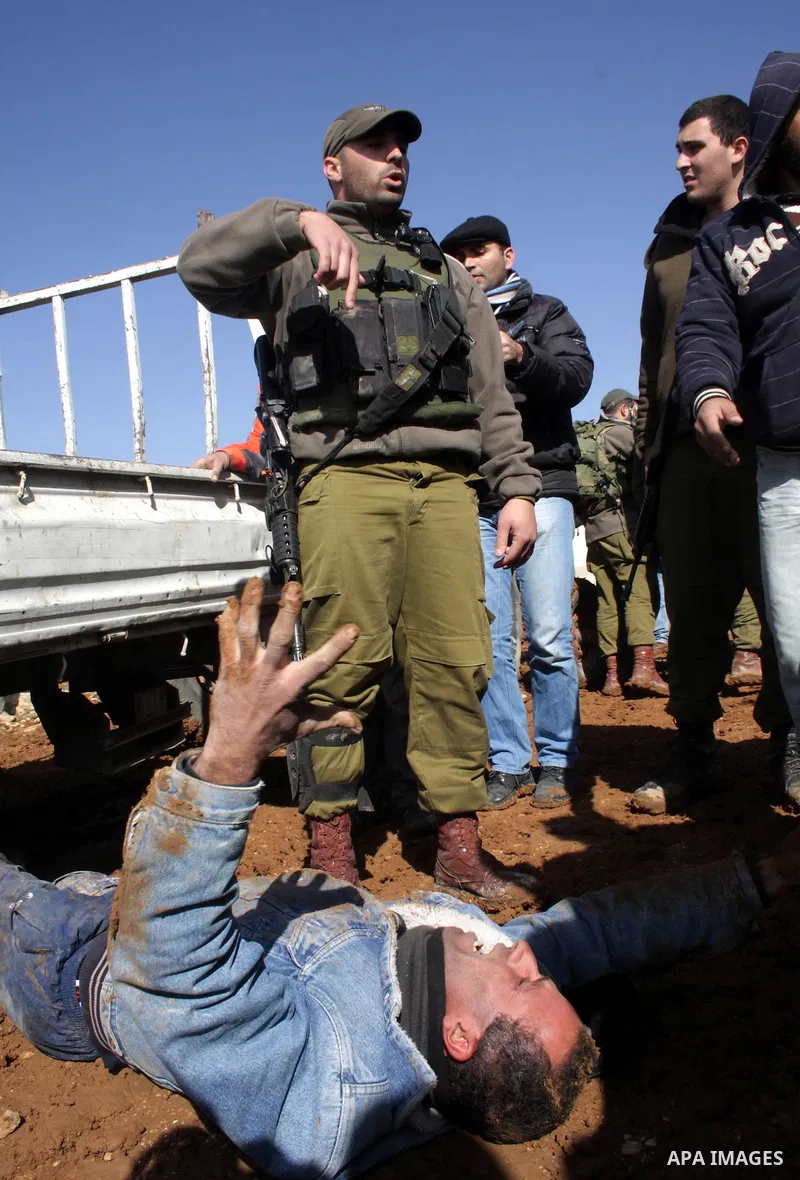 Palestinian bedouin scuffle with Israeli soldiers in Oum al-Khair village southern West Bank city of Hebron on January 25, 2012, after the Israeli army stopped building their house and confiscated the construction materi...