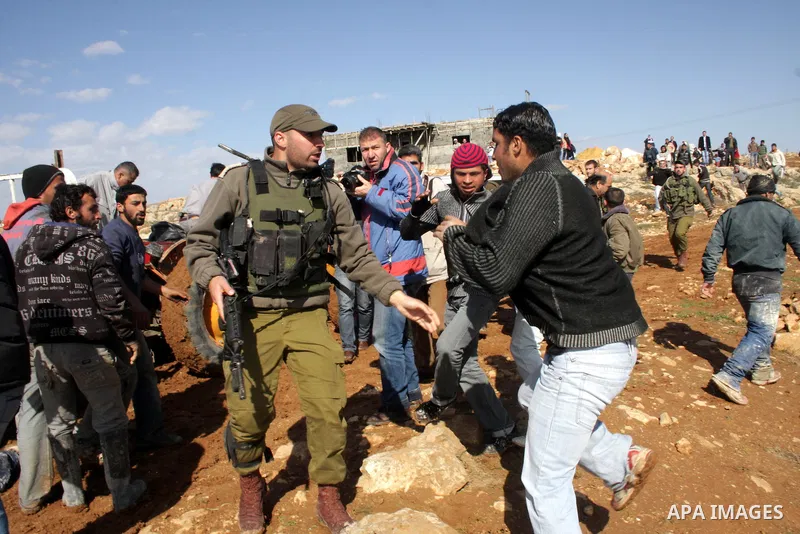 Palestinian bedouin scuffle with Israeli soldiers in Oum al-Khair village southern West Bank city of Hebron on January 25, 2012, after the Israeli army stopped building their house and confiscated the construction materi...