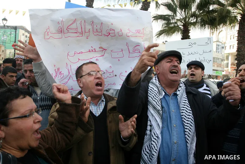 Palestinians demonstrate in the commercial capital of the West Bank city of Ramallah to protest the high cost of living and against adopted policy by Palestinian prime minister Salam Fayyad on January 25, 2012. Photo by...