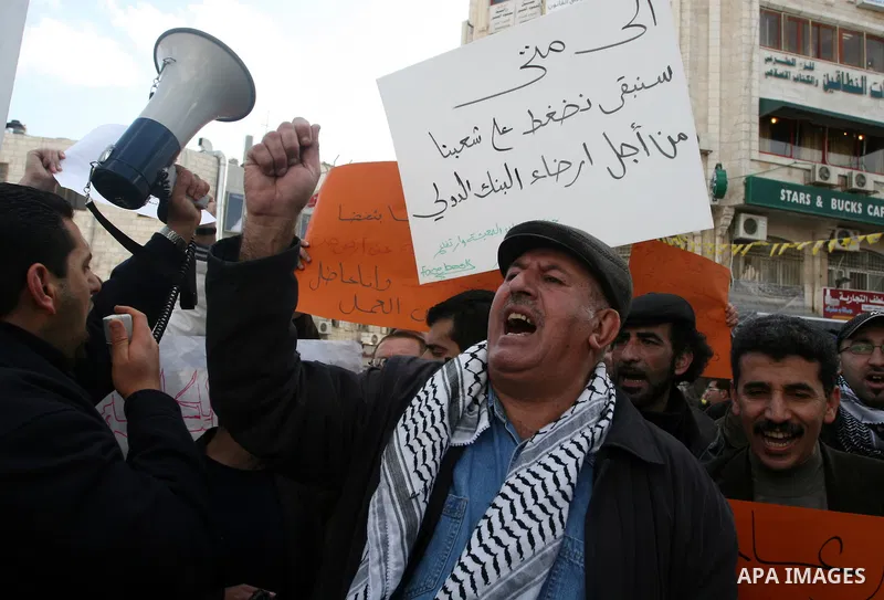 Palestinians demonstrate in the commercial capital of the West Bank city of Ramallah to protest the high cost of living and against adopted policy by Palestinian prime minister Salam Fayyad on January 25, 2012. Photo by...