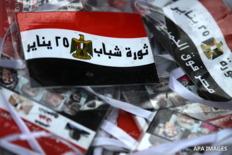 Banners are seen during a protest to celebrate the one year anniversary of the 25th January uprising at Tahrir square in Cairo, Egypt, 25 January 2012. One year earlier the same day Egyptians started an uprising which re...