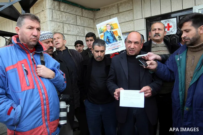 Palestinians participate in a demonstration calling for release of Journalist Raed Sharif, held in the Israeli jails . in the West Bank city of Hebron, Jan. 26, 2012. Israel is currently holding thousands of Palestinians...