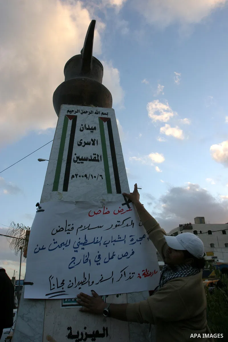 Palestinians demonstrate in Al-Azariya, on the outskirts of Jerusalem, to protest the high cost of living and against recent austerity measures announced by Palestinian prime minister Salam Fayyad (on poster) on January...