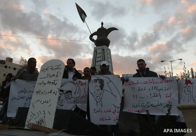 Palestinians demonstrate in Al-Azariya, on the outskirts of Jerusalem, to protest the high cost of living and against recent austerity measures announced by Palestinian prime minister Salam Fayyad (on poster) on January...