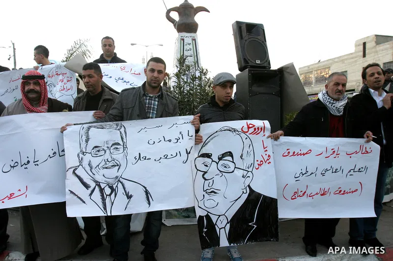 Palestinians demonstrate in Al-Azariya, on the outskirts of Jerusalem, to protest the high cost of living and against recent austerity measures announced by Palestinian prime minister Salam Fayyad (on poster) on January...