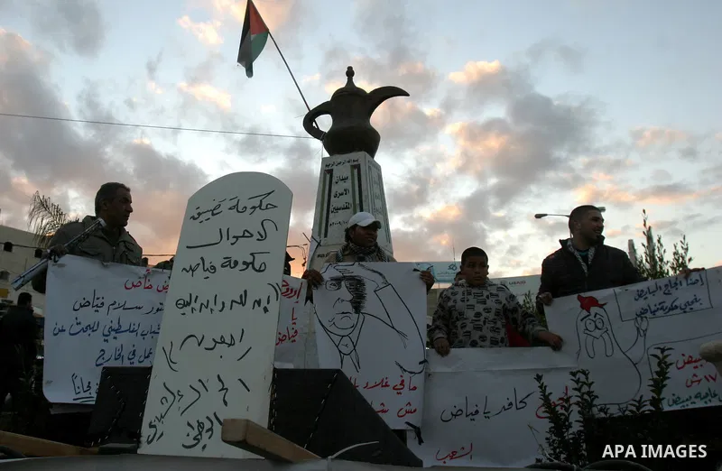 Palestinians demonstrate in Al-Azariya, on the outskirts of Jerusalem, to protest the high cost of living and against recent austerity measures announced by Palestinian prime minister Salam Fayyad (on poster) on January...