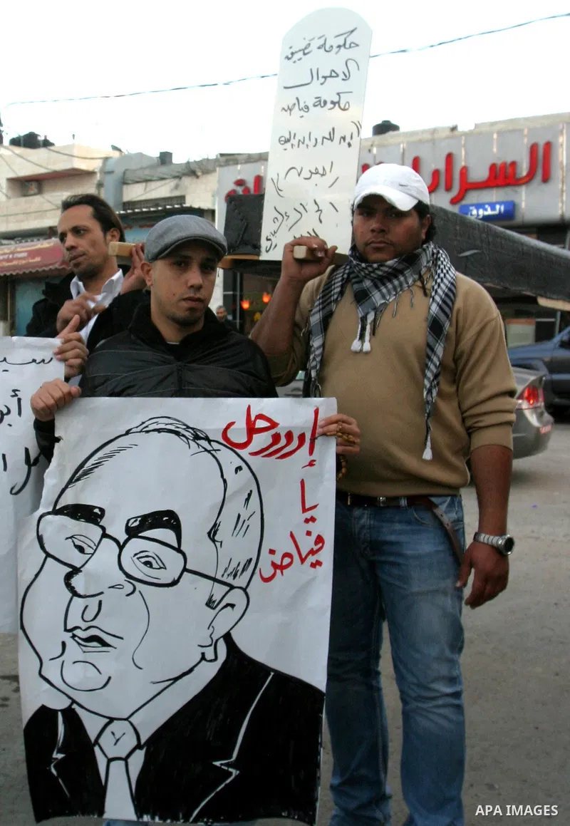 Palestinians demonstrate in Al-Azariya, on the outskirts of Jerusalem, to protest the high cost of living and against recent austerity measures announced by Palestinian prime minister Salam Fayyad (on poster) on January...