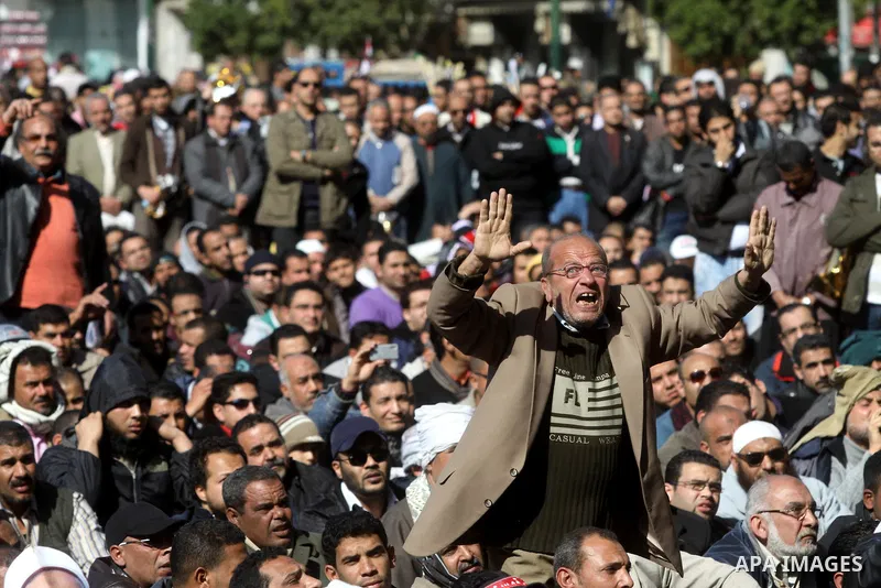 Egyptian demonstrators gather during a protest demanding the army to hand power to civilians at Tahrir square in Cairo on January 27, 2012, a year after a popular uprising. The protesters are demanding the implementation...