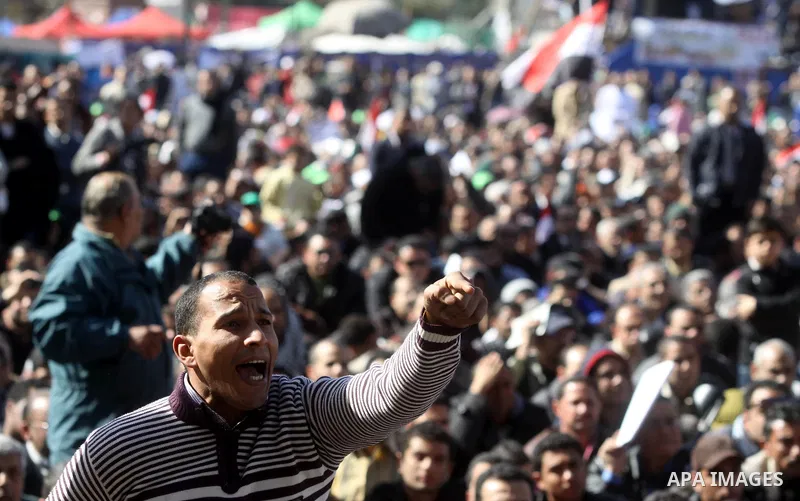 Egyptian demonstrators gather during a protest demanding the army to hand power to civilians at Tahrir square in Cairo on January 27, 2012, a year after a popular uprising. The protesters are demanding the implementation...