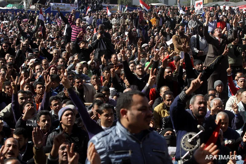 Egyptian demonstrators gather during a protest demanding the army to hand power to civilians at Tahrir square in Cairo on January 27, 2012, a year after a popular uprising. The protesters are demanding the implementation...