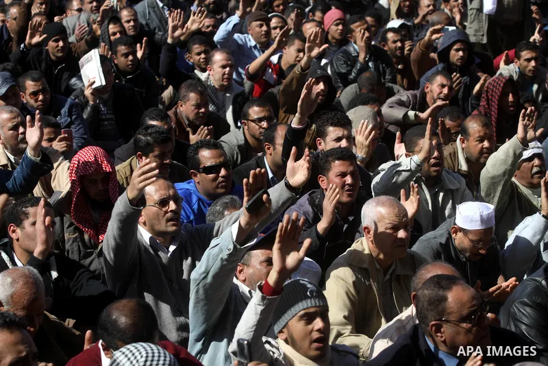 Egyptian demonstrators gather during a protest demanding the army to hand power to civilians at Tahrir square in Cairo on January 27, 2012, a year after a popular uprising. The protesters are demanding the implementation...