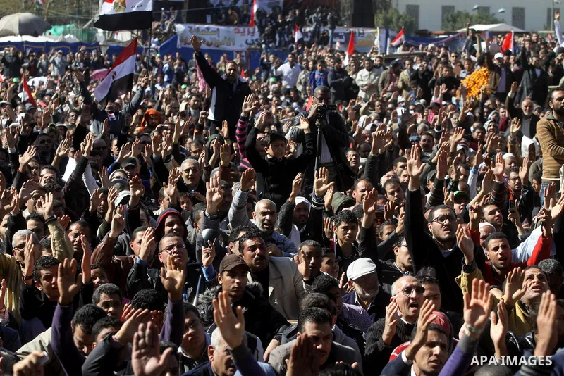 Egyptian demonstrators gather during a protest demanding the army to hand power to civilians at Tahrir square in Cairo on January 27, 2012, a year after a popular uprising. The protesters are demanding the implementation...