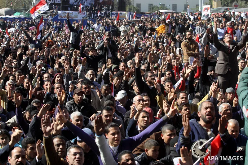 Egyptian demonstrators gather during a protest demanding the army to hand power to civilians at Tahrir square in Cairo on January 27, 2012, a year after a popular uprising. The protesters are demanding the implementation...