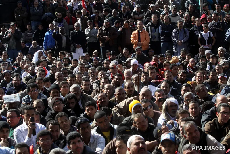 Egyptian demonstrators gather during a protest demanding the army to hand power to civilians at Tahrir square in Cairo on January 27, 2012, a year after a popular uprising. The protesters are demanding the implementation...