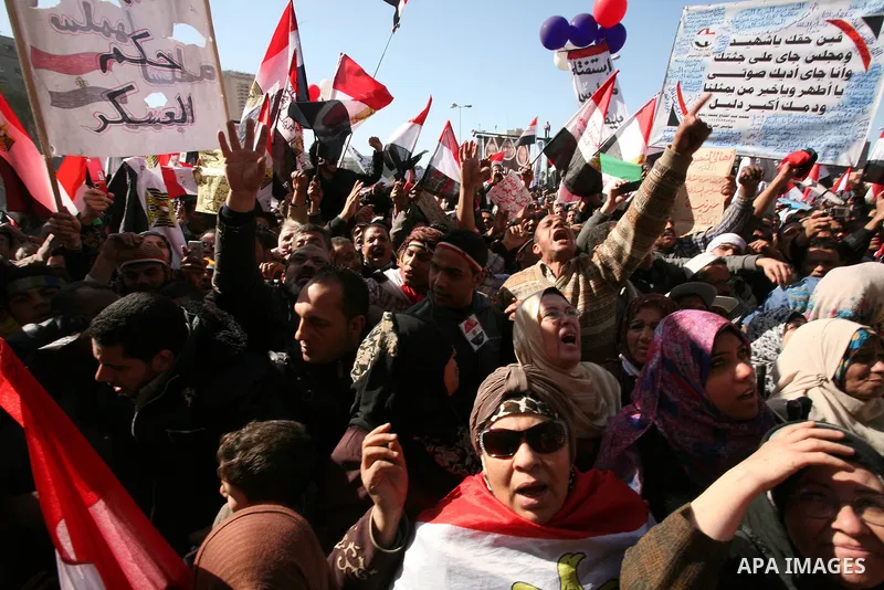 Egyptian demonstrators gather during a protest demanding the army to hand power to civilians at Tahrir square in Cairo on January 27, 2012, a year after a popular uprising. The protesters are demanding the implementation...