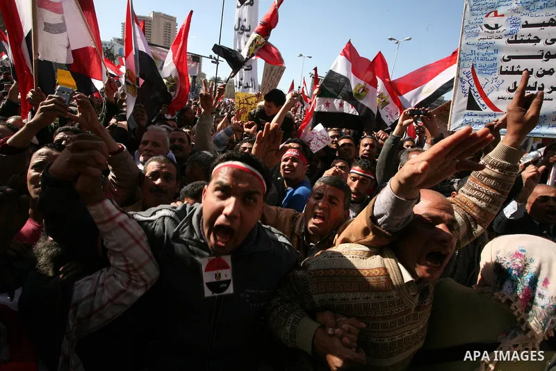 Egyptian demonstrators gather during a protest demanding the army to hand power to civilians at Tahrir square in Cairo on January 27, 2012, a year after a popular uprising. The protesters are demanding the implementation...