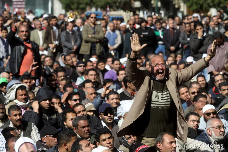Egyptian demonstrators gather during a protest demanding the army to hand power to civilians at Tahrir square in Cairo on January 27, 2012, a year after a popular uprising. The protesters are demanding the implementation...