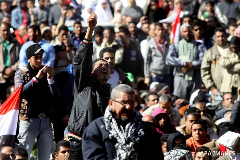 Egyptian demonstrators gather during a protest demanding the army to hand power to civilians at Tahrir square in Cairo on January 27, 2012, a year after a popular uprising. The protesters are demanding the implementation...